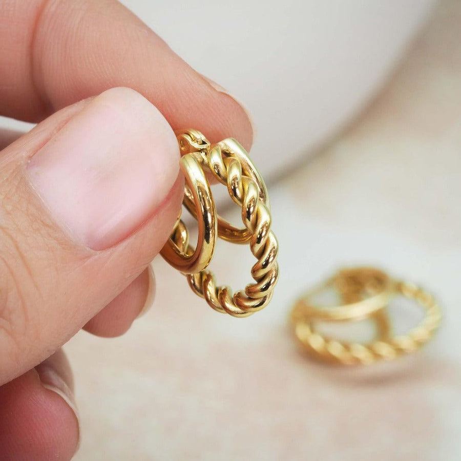 Hand holding gold hoop earrings - womens jewellery by Australian waterproof jewellery brands indie and harper