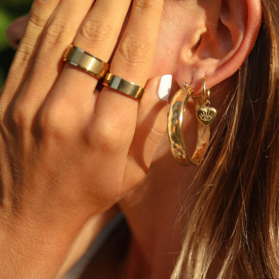 Woman wearing Gold Hoop Earrings and gold rings - gold waterproof jewellery by australian jewellery brands indie and harper