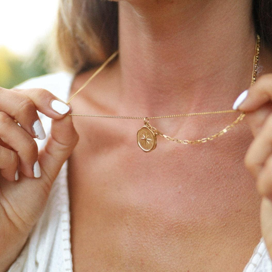 woman with white nails wearing gold layered necklace - gold jewellery by australian jewellery brands indie and harper