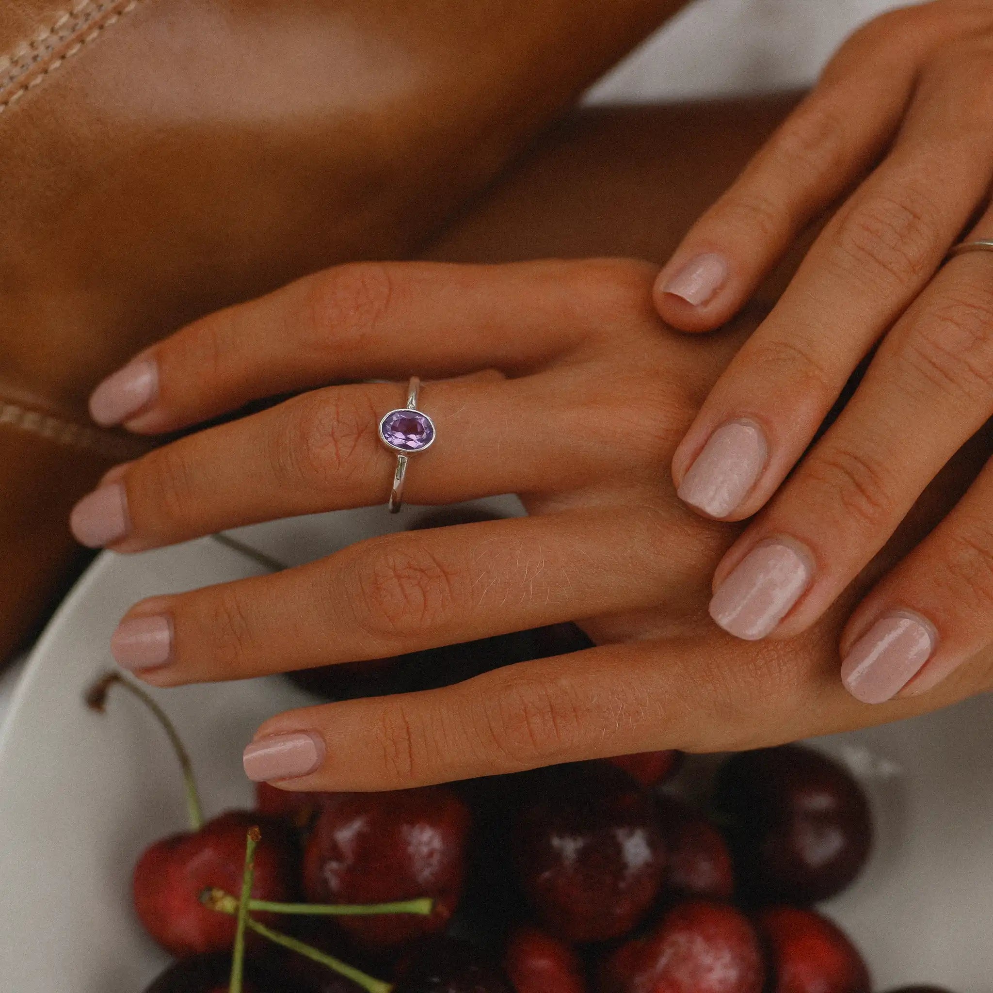 woman wearing dainty sterling silver amethyst ring - women's amethyst jewellery by australian online jewellery brand indie and harper