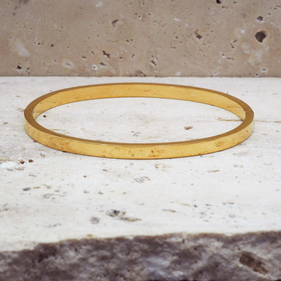 oval bangle made with hinge design - waterproof jewellery made from stainless steel with gold plating by online jewellery brand indie and harper