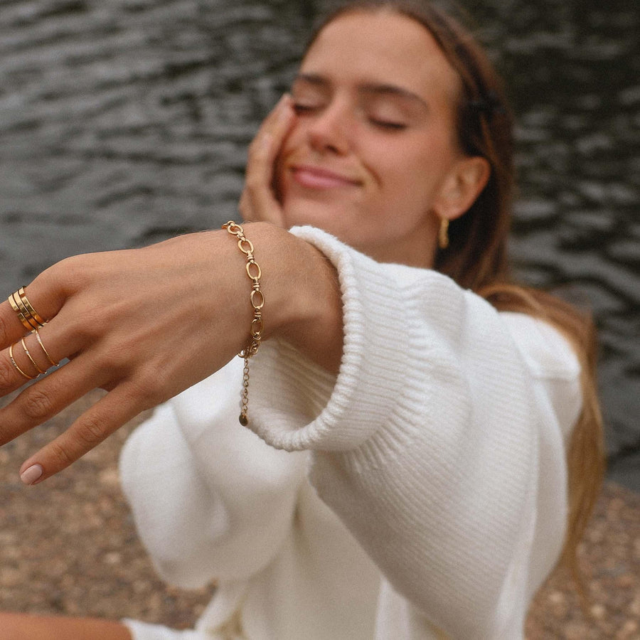 woman in white jumper wearing gold bracelet - womens gold jewellery by Australian jewellery brands indie and harper