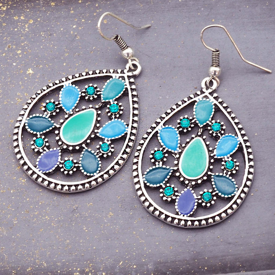blue and green bohemian earrings - metal alloy earrings with coloured enamel detailing - classic french hook earrings by online jewellery brand indie and harper
