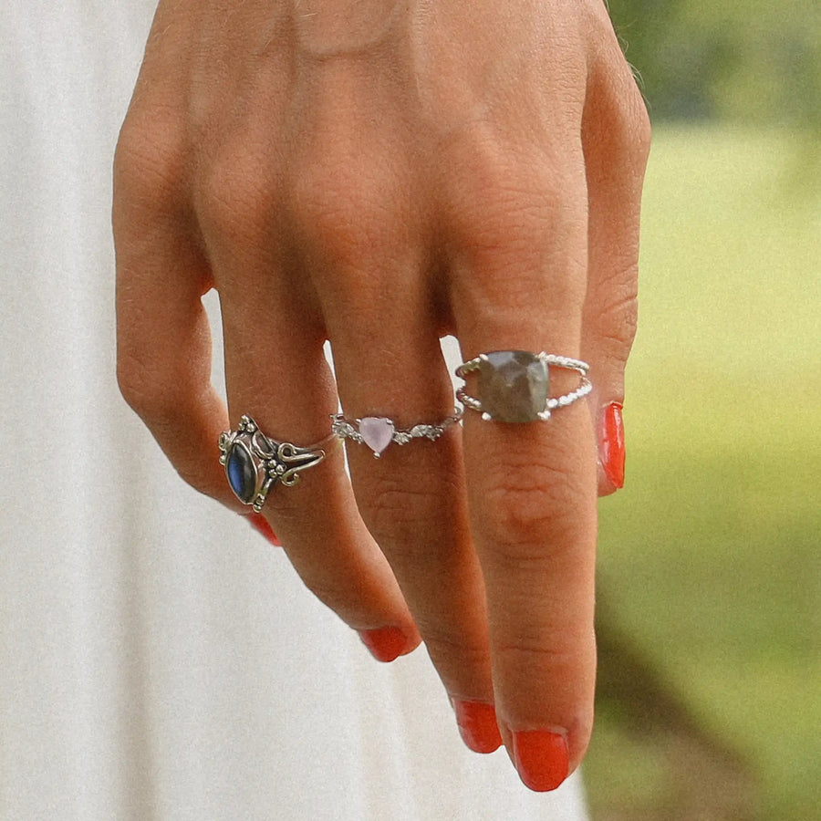 woman wearing three sterling silver rings with labradorite and pink opal stones - women's boho jewellery by Australian jewellery brands indie and harper