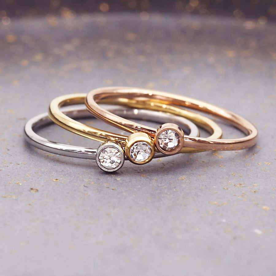 dainty birthstone ring - april birthstone jewellery made with stainless steel, gold and rose gold plating and cubic zirconia gemstones - dainty april birthstone ring by online jewellery brand indie and harper