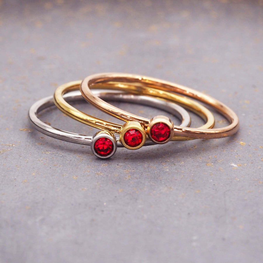 dainty birthstone ring - dainty january birthstone jewellery made with gold and rose gold plating over stainless steel and a red cubic zirconia gemstone - dainty january birthstone ring by online jewellery brand indie and harper