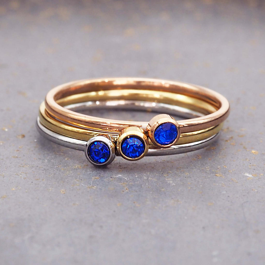 dainty birthstone ring - dainty september birthstone rings made with dainty blue cubic zirconia gemstones, stainless steel, gold and rose gold plating - dainty september birthstone ring by online brand indie and harper