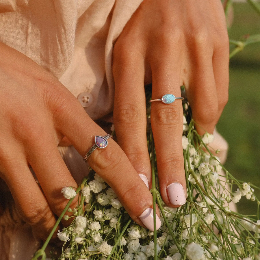 woman wearing sterling silver opal rings - opal jewellery by womens jewelry online brand indie and harper