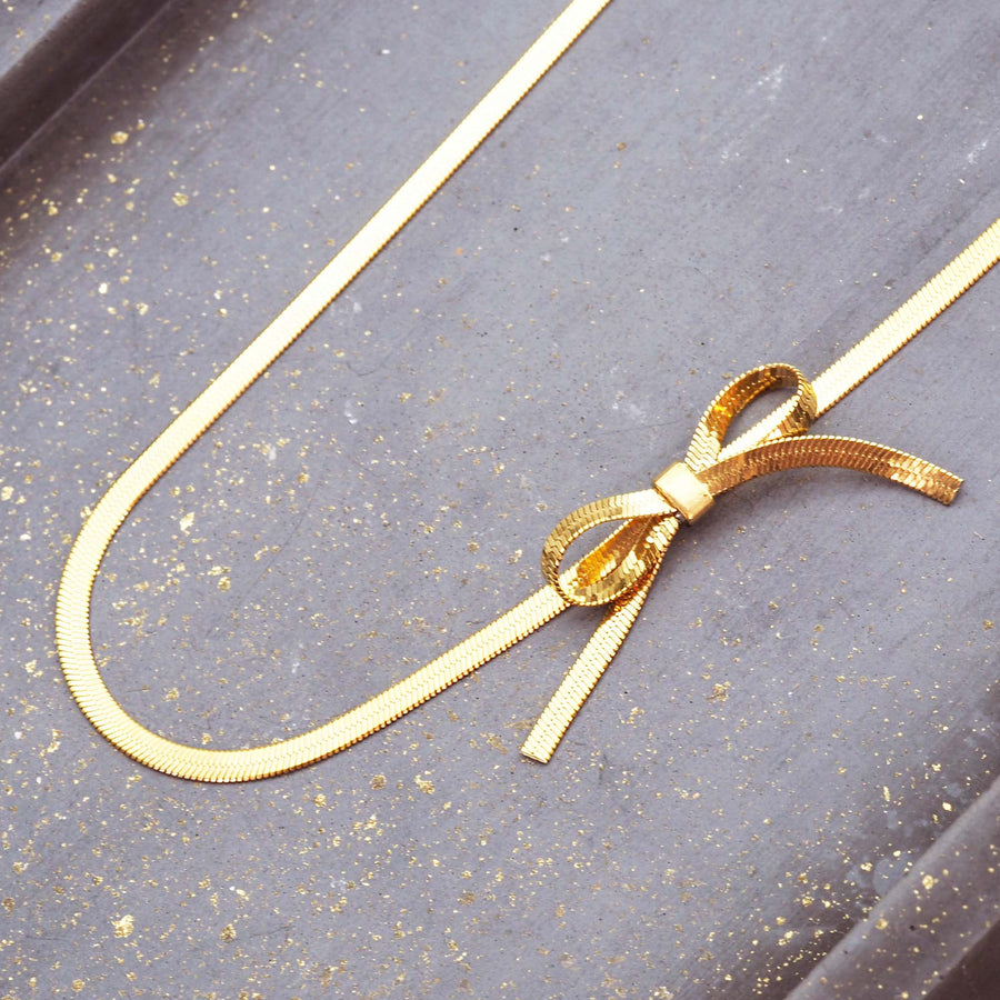 dainty bow choker necklace - beautiful snake chain necklace with a dainty bow detail made from stainless steel with 18k gold plating - dainty waterproof jewellery online by indie and harper