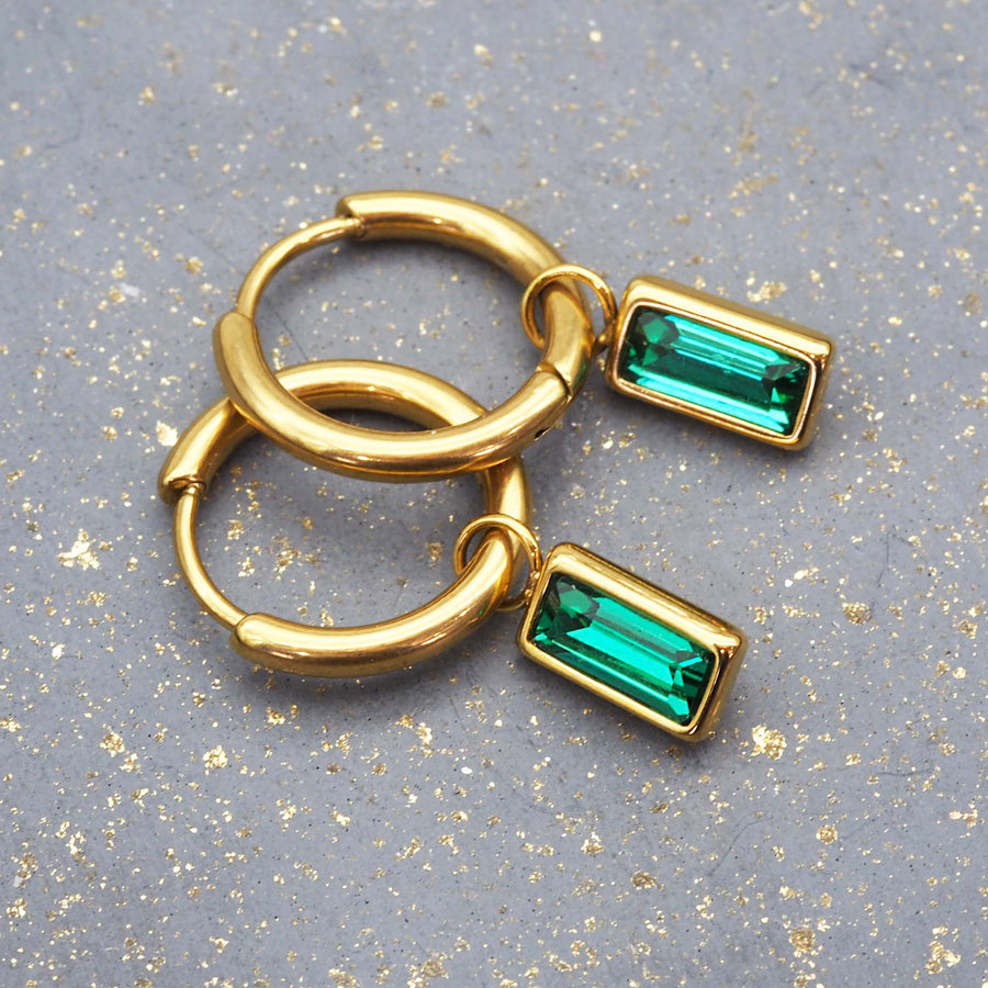 dainty gold and emerald green earrings - waterproof jewellery for women made with titanium steel, 18k gold plating and emerald green cubic zirconia - waterproof jewellery by online jewellery brand indie and harper