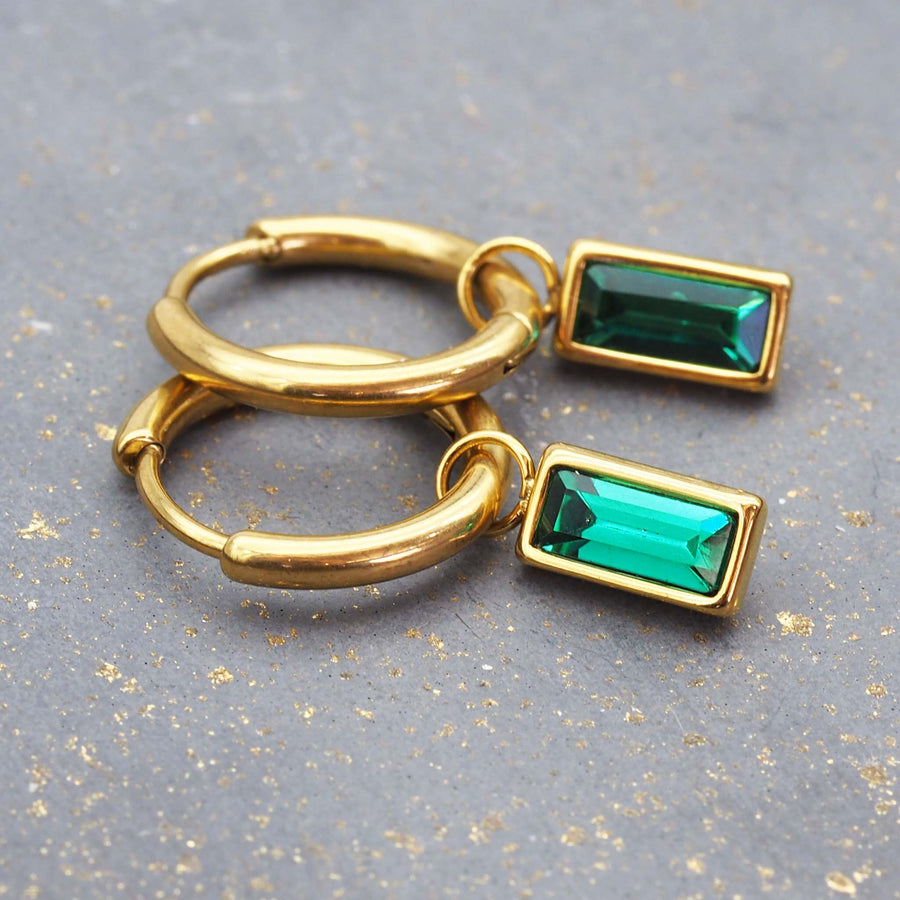 dainty gold and emerald green earrings - dainty hoop earrings with emerald green charms and made with titanium steel and 18k gold plating - waterproof jewellery by online jewellery brand indie and harper