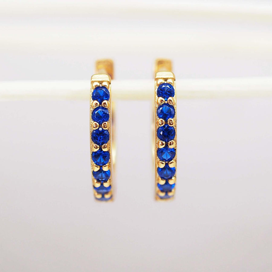 dainty Gold huggie earrings with blue cubic zirconias - womens gold jewellery by Australian jewellery brands online indie and Harper 