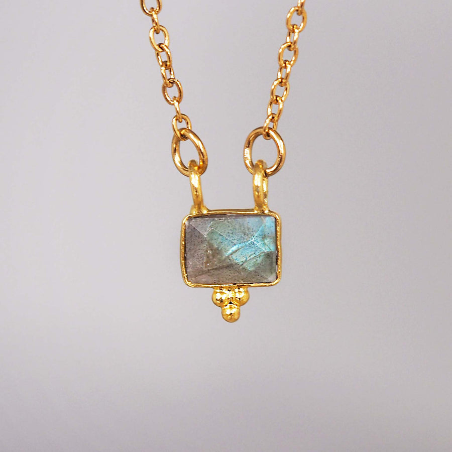 dainty gold gemstone necklace - made with stainless steel, gold plating and a beautiful faceted natural labradorite gemstone - handcrafted gold necklace by online jewellery brand indie and harper