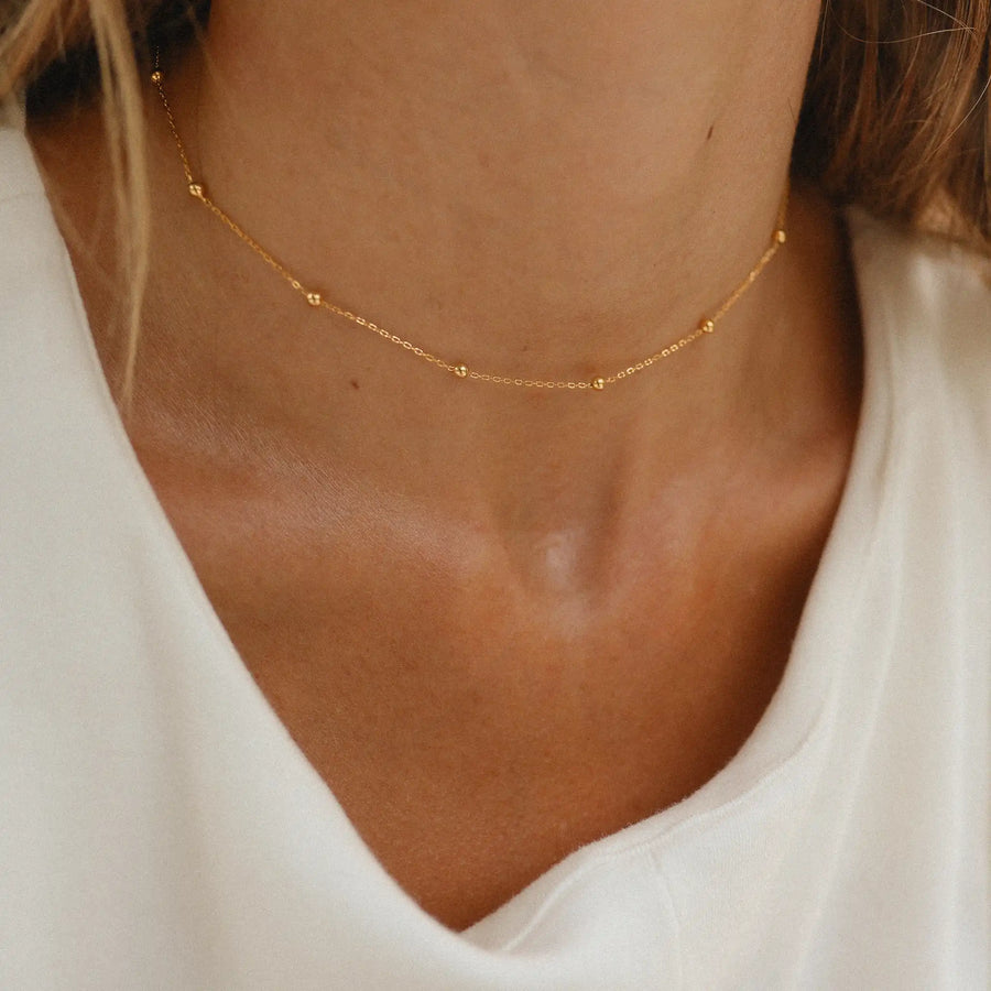 dainty gold necklace being worn - gold jewellery by online jewellery brand indie and harper