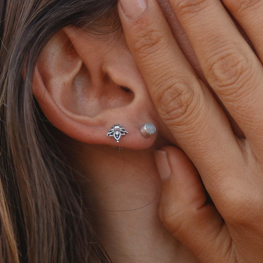 Woman wearing dainty sterling silver moonstone earrings - moonstone jewellery and sterling silver earrings by Australian jewellery brands indie and harper