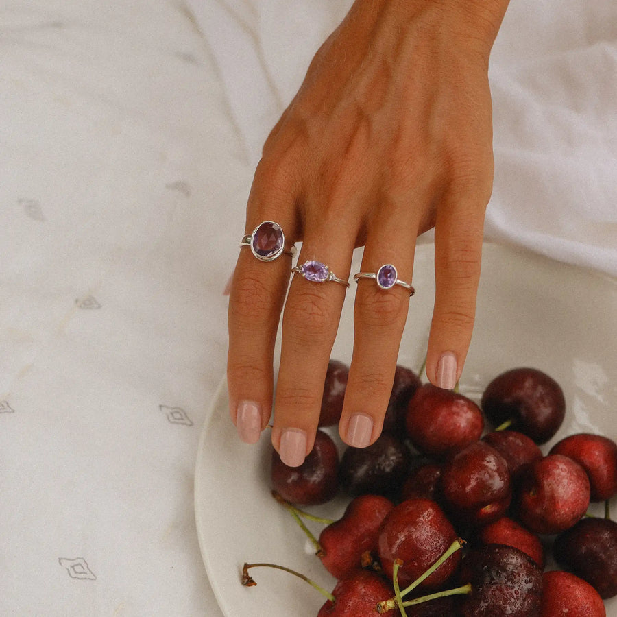 Sterling silver amethyst rings being worn - amethyst jewellery by online jewellery brand indie and harper