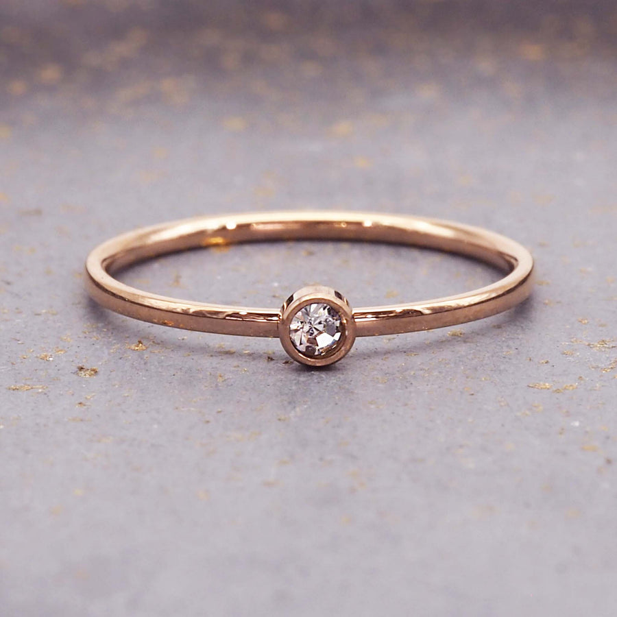 dainty rose gold birthstone ring - stainless steel with rose gold plating and a dainty cubic zirconia gemstone - dainty rose gold april birthstone ring by online jewellery brand indie and harper