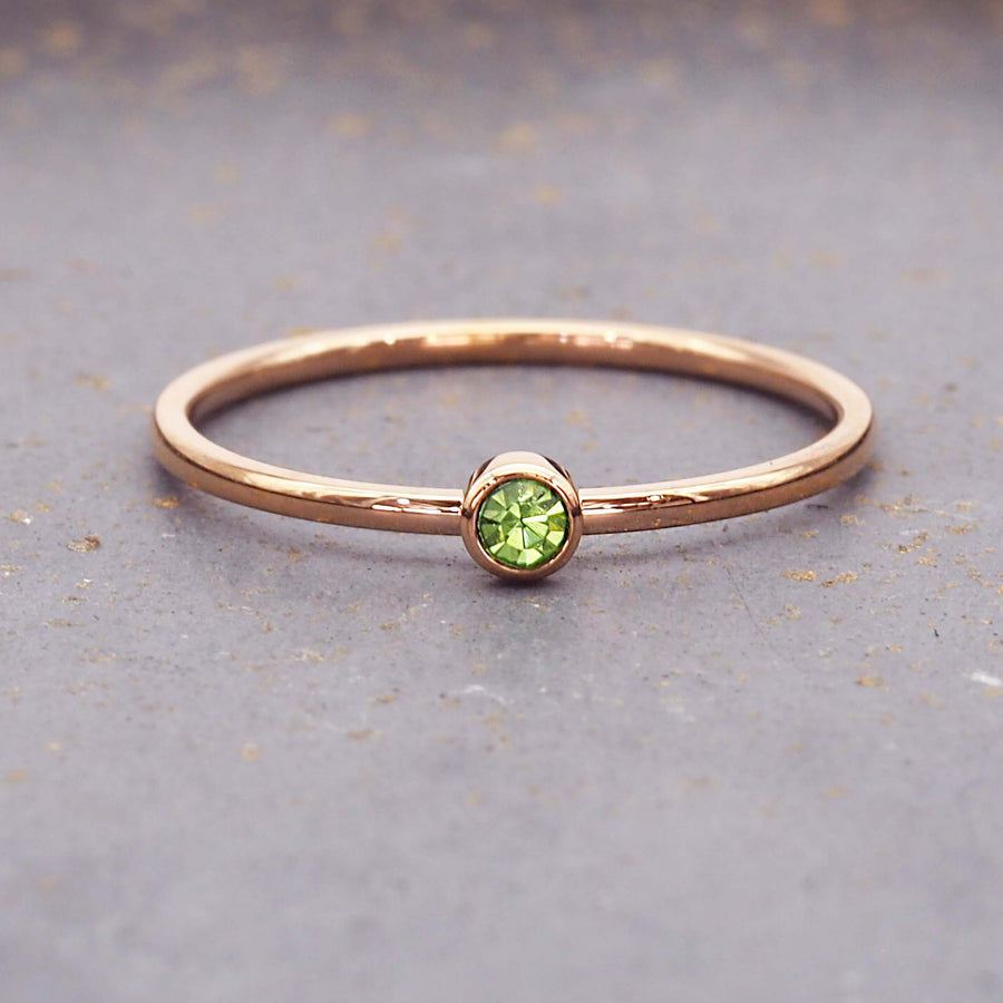 dainty rose gold birthstone ring - august birthstone jewellery made with green cubic zirconia gemstone, stainless steel and rose gold plating - dainty rose gold august birthstone ring by online jewellery brand indie and harper