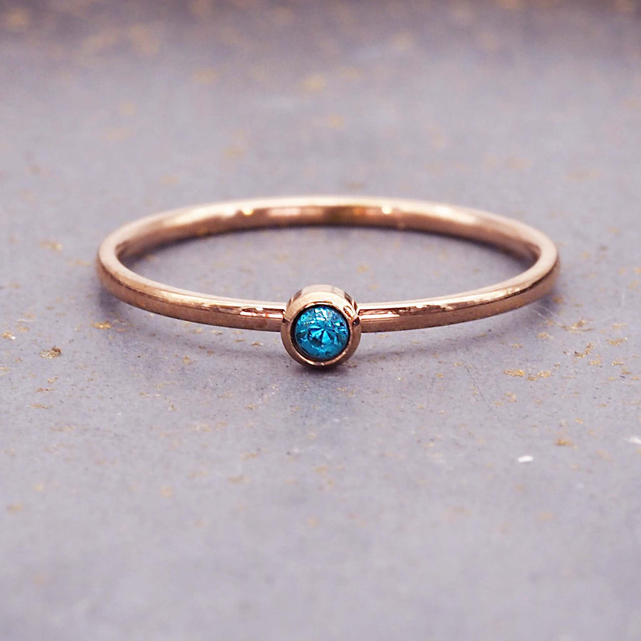 dainty rose gold birthstone ring - dainty december birthstone jewellery made with stainless steel and rose gold plating with a dainty light blue cubic zirconia - dainty rose gold december birthstone ring by online jewellery brand indie and harper