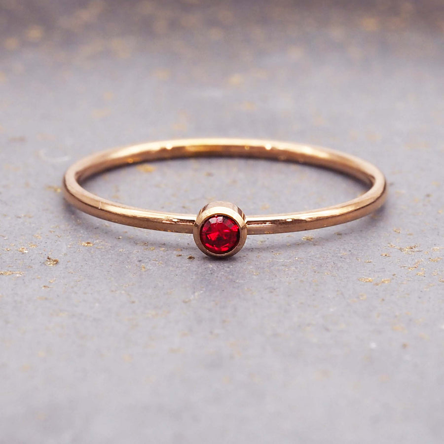 dainty rose gold birthstone ring - dainty rose gold janurary birthstone ring made with rose gold plating over stainless steel and red cubic zirconia gemstone - dainty rose gold janurary birthstone ring by online jewellery brand indie and harper