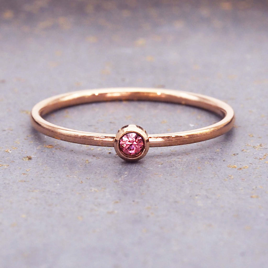 dainty rose gold birthstone ring - stainless steel july birthstone ring with rose gold plating and pink cubic zirconia gemstone - dainty rose gold july birthstone ring by online jewellery brand indie and harper