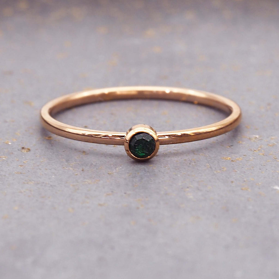 dainty rose gold birthstone ring - stainless steel may birthstone ring with gold plating and emerald green cubic zirconia gemstone - dainty rose gold may birthstone ring by online jewellery brand indie and harper