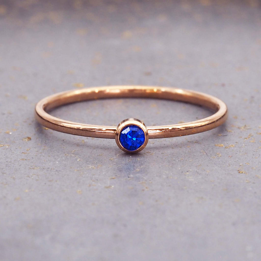dainty rose gold birthstone ring - september birthstone jewellery made with blue cubic zirconia, stainless steel and rose gold plating - dainty rose gold september birthstone ring by online jewellery brand indie and harper
