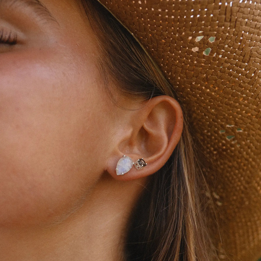 woman wearing dainty stud earrings with smokey quartz crystal stone - unique gemstone jewellery by indie and harper