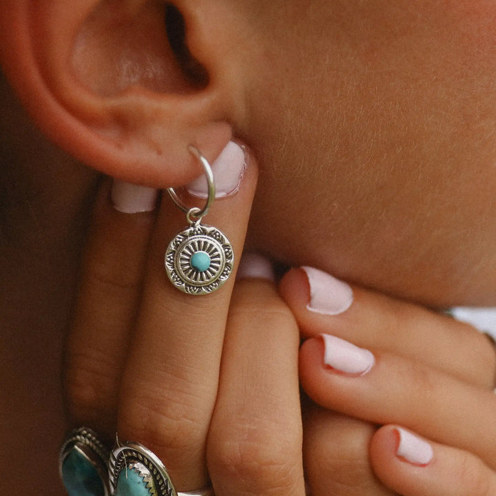 woman wearing dainty mandala turquoise earrings - sterling silver earrings by boho jewellery brand indie and harper