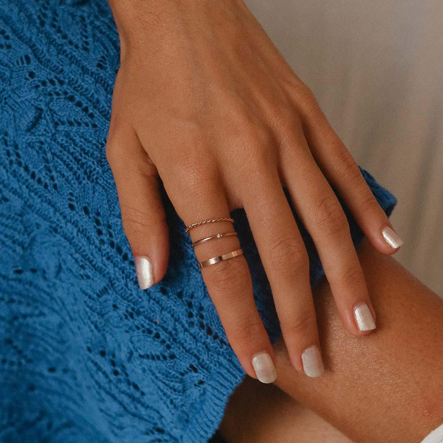 womans hand wearing rose gold rings - rose gold jewellery australia by australian jewellery brands indie and harper