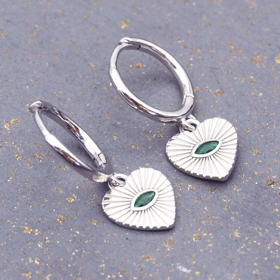 dainty white gold plated sterling silver earrings with green cubic zirconia and heart charms - women's dainty earrings by online jewellery brand indie and harper