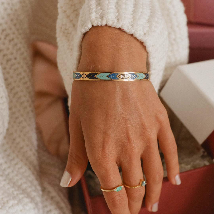 woman wearing blue enamel and gold bracelet - gold jewellery by waterproof jewellery brand indie and Harper 