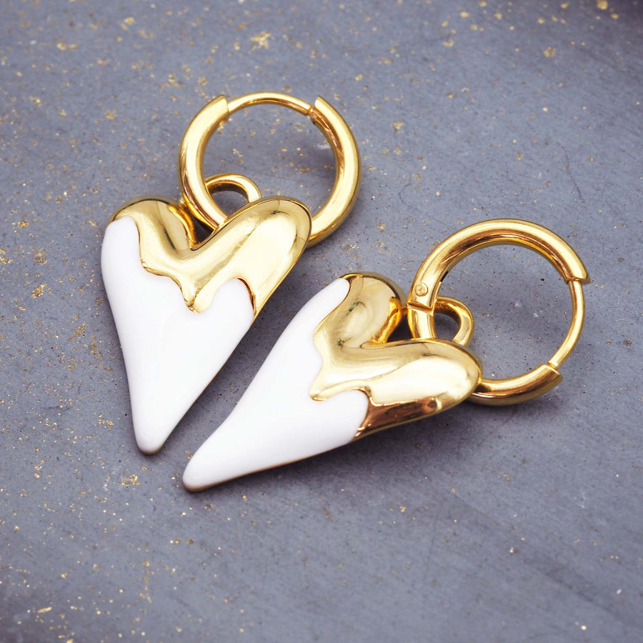 heart shaped earrings made with beautiful gold plating over stainless steel and white enamel - waterproof jewellery by online jewellery brand indie and harper