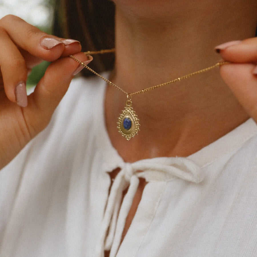 woman wearing gold necklace with natural gemstone - women's bohemian jewelry by indie and harper