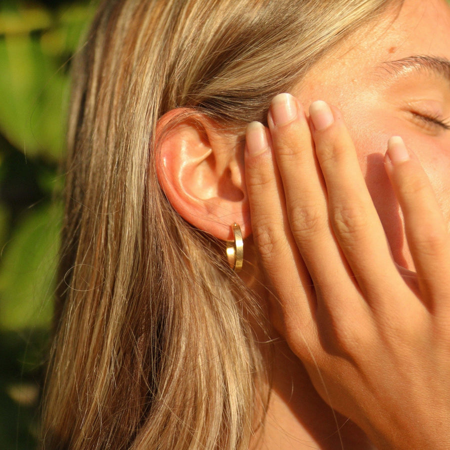 Woman wearing gold hoop Earrings - gold jewellery by Australian waterproof jewellery brands indie and Harper