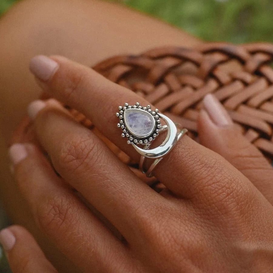 Woman's hand wearing a sterling silver half moon moonstone ring - moonstone jewellery by women’s jewelry brand indie and Harper