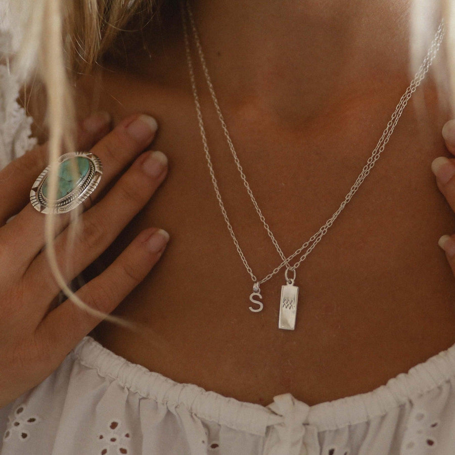 sterling silver S initial necklace and silver zodiac necklace being worn - womens jewellery by australian jewellery brands indie and harper