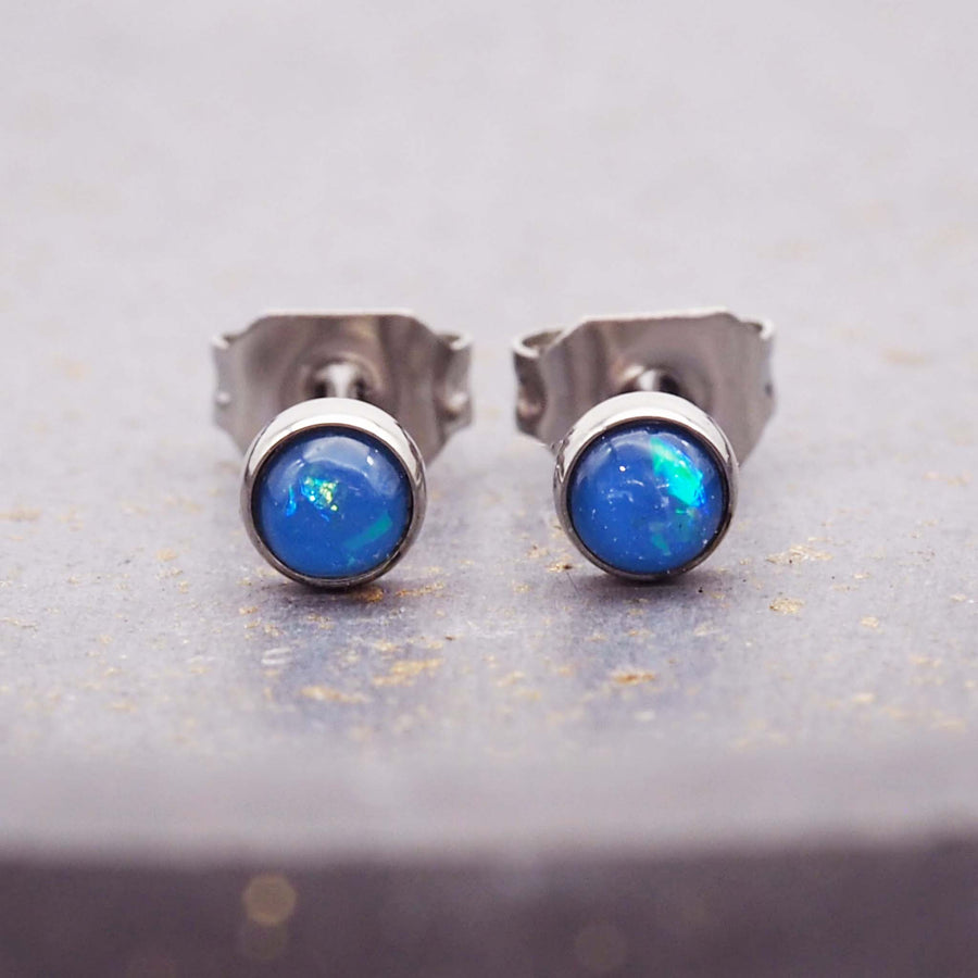 waterproof earrings made with stainless steel and synthetic blue opals - women's earrings by online jewellery brand indie and harper