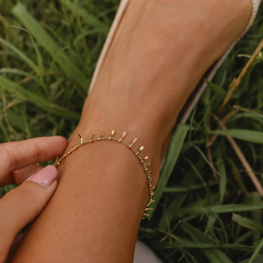 Woman wearing gold anklet - gold jewellery by Australian waterproof jewellery brands indie and harper