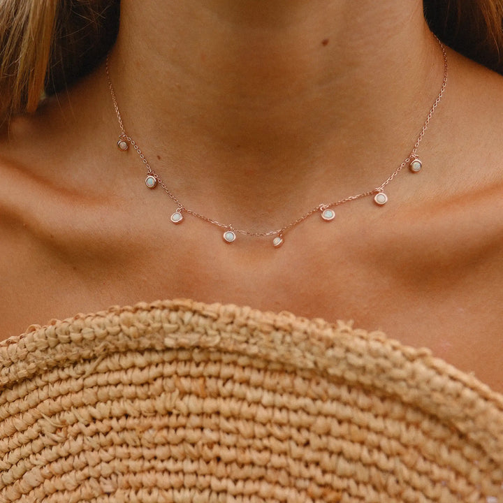 woman wearing rose gold necklace with dainty opal stones - rose gold jewellery by australian jewellery brands indie and harper