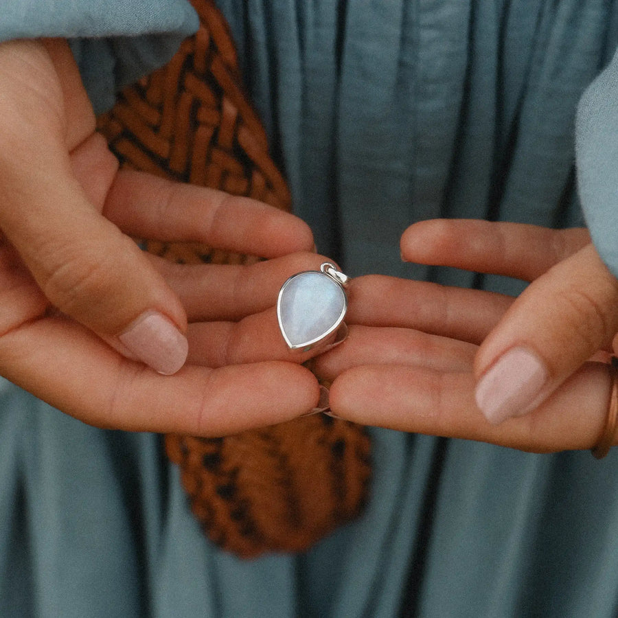 Woman holding large moonstone pendant - moonstone jewellery by Australian jewellery brands indie and harper 