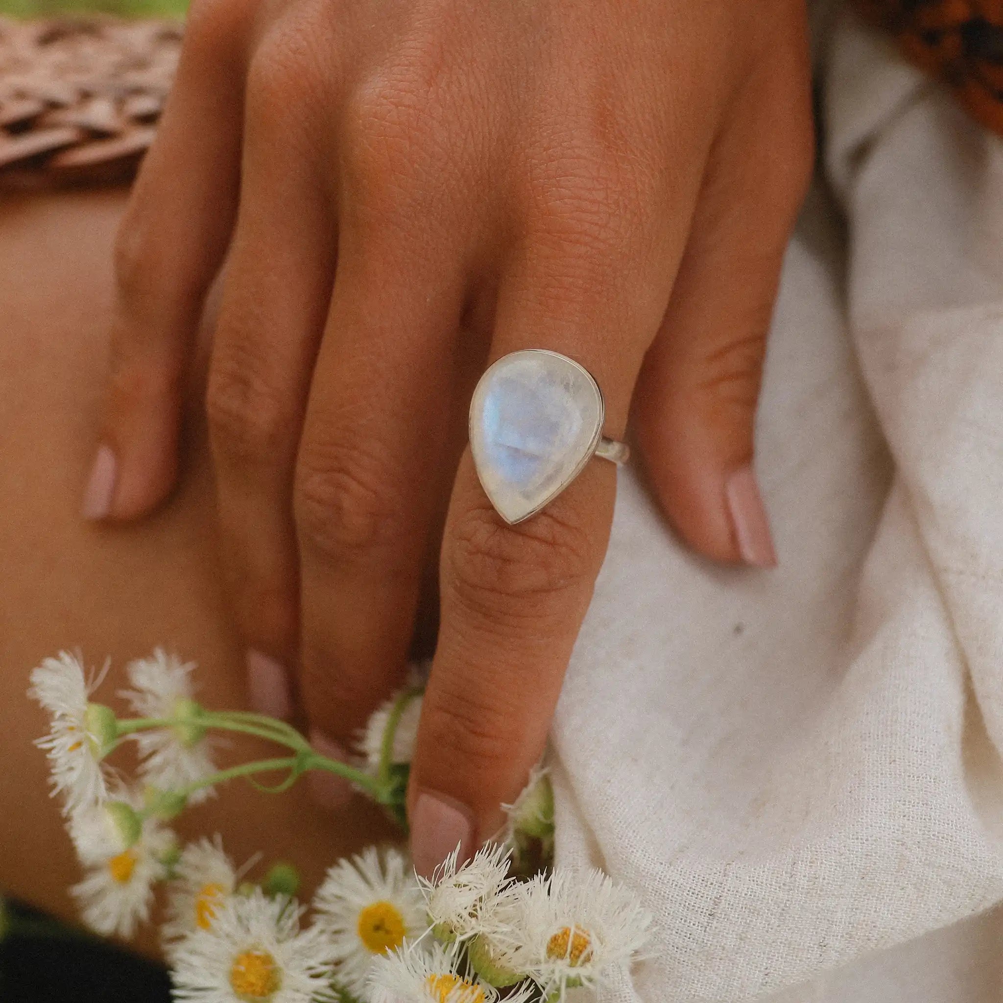 Woman's hand wearing sterling silver moonstone ring - moonstone jewelry by australian jewellery brands indie and harper