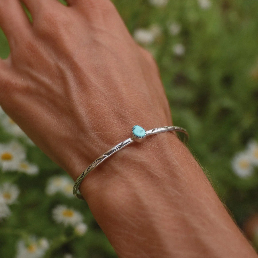 Woman wearing a sterling silver Navajo hand carved turquoise bracelet - Native American Jewelry and turquoise jewellery by Australian jewellery brands online indie and Harper 