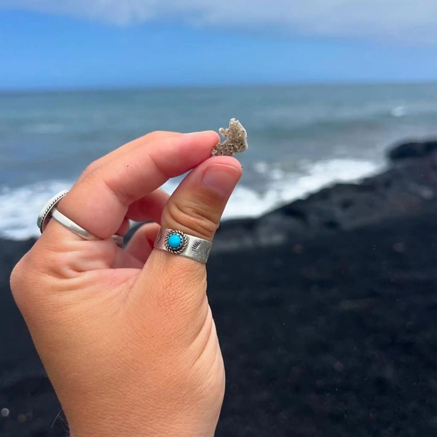 woman holding coral wearing sterling silver turquoise ring - native american jewelry by womens jewellery brand indie and harper