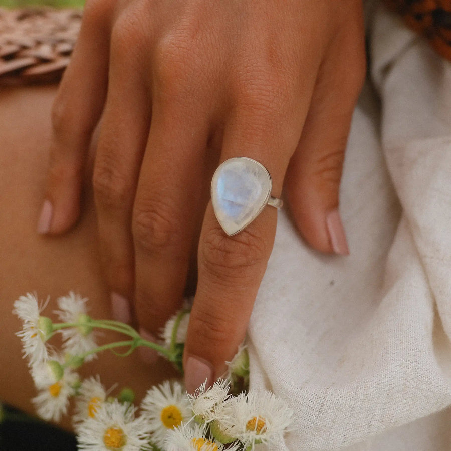 Woman's hand wearing sterling silver moonstone rings - moonstone jewelry by womens jewelry brand indie and harper