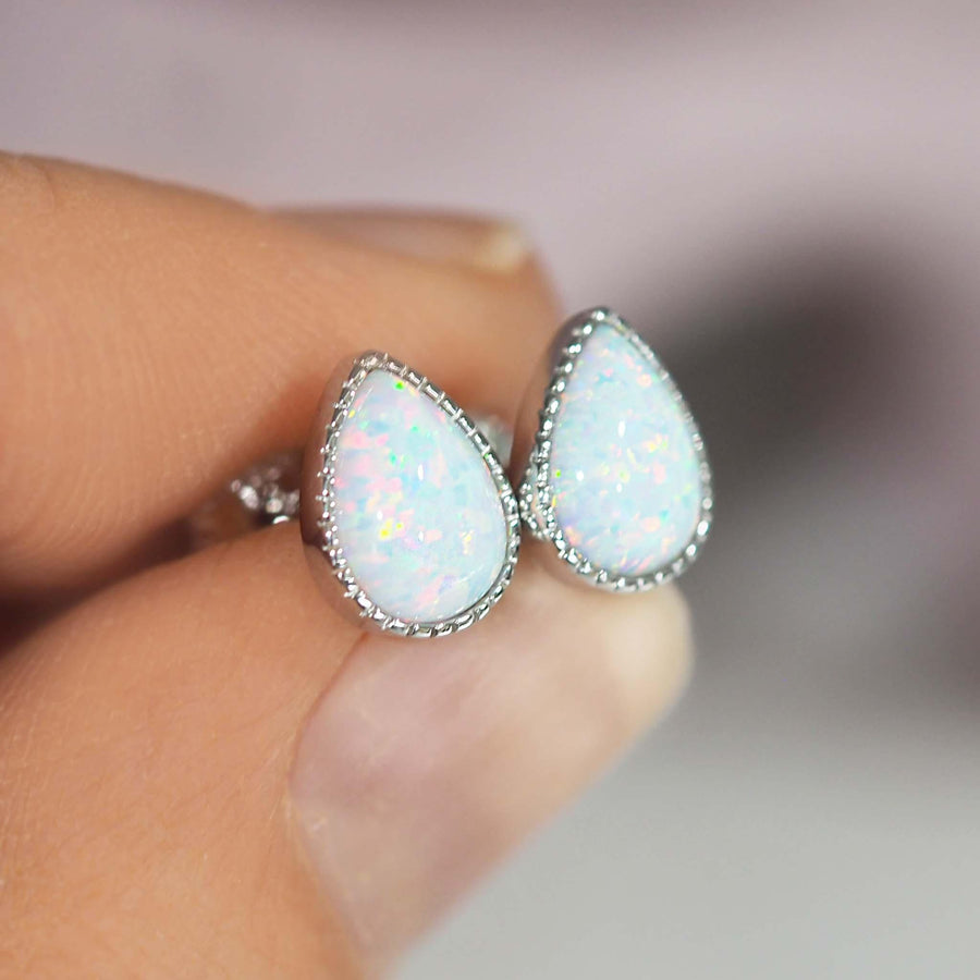 fingers holding White Opal Earrings - womens opal jewellery by australian jewellery brands indie and harper