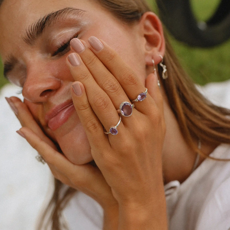 woman wearing three sterling silver amethyst rings - amethyst jewelry by online jewelry brand indie and Harper 