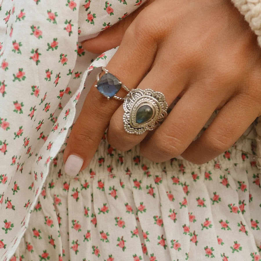 Close up of woman's hand wearing two sterling silver Labradorite rings - boho jewellery by australian jewellery brands indie and harper