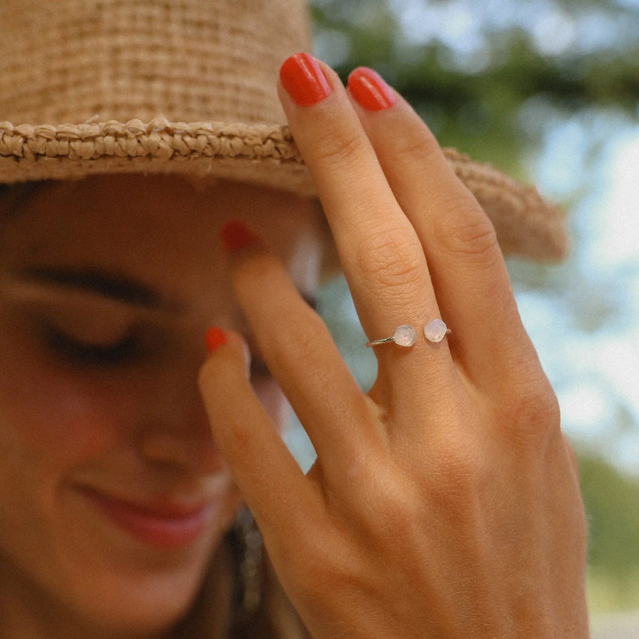 woman wearing dainty sterling silver raw opal ring - raw opal jewelry by womens jewelry brand indie and harper