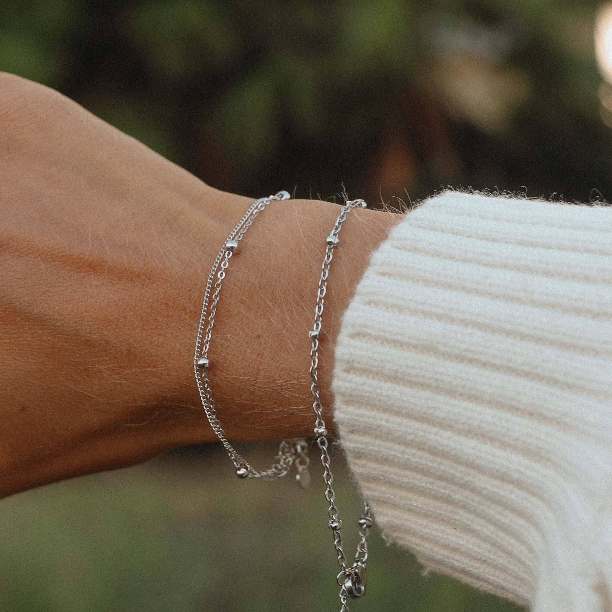 Woman with white jumper wearing Sterling Silver Bracelets - womens jewellery by Australian jewellery brands online indie and harper